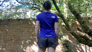 Back of a runner wearing blue top