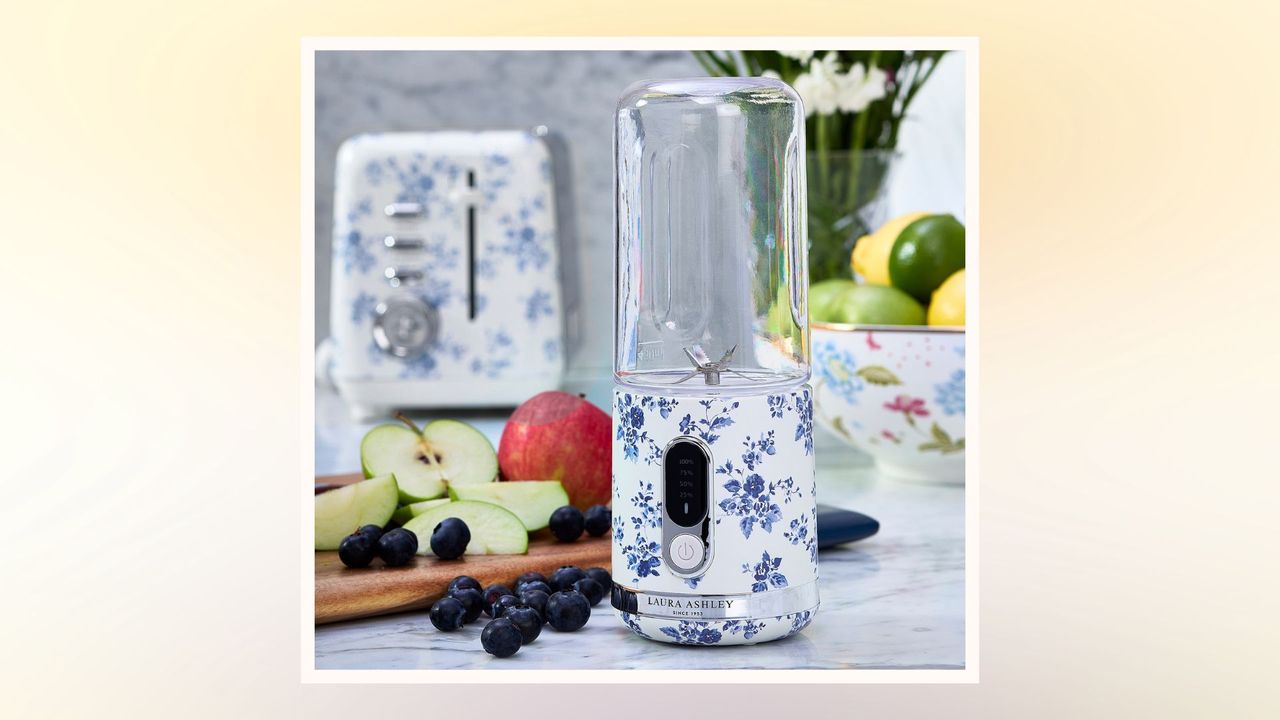 Laura Ashley Portable Smoothie Maker in a kitchen beside a wooden platter of chopped fruit