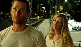 Serenity Anne Hathaway stands behind Matthew McConaughey, trying to lure him in