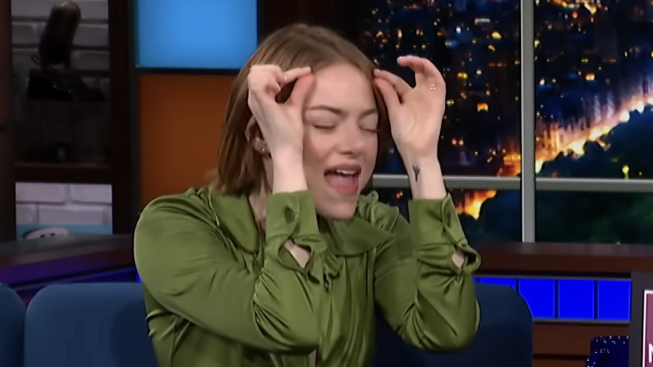 Emma Stone pretending to adjust a wig on The Late Show with Stephen Colbert