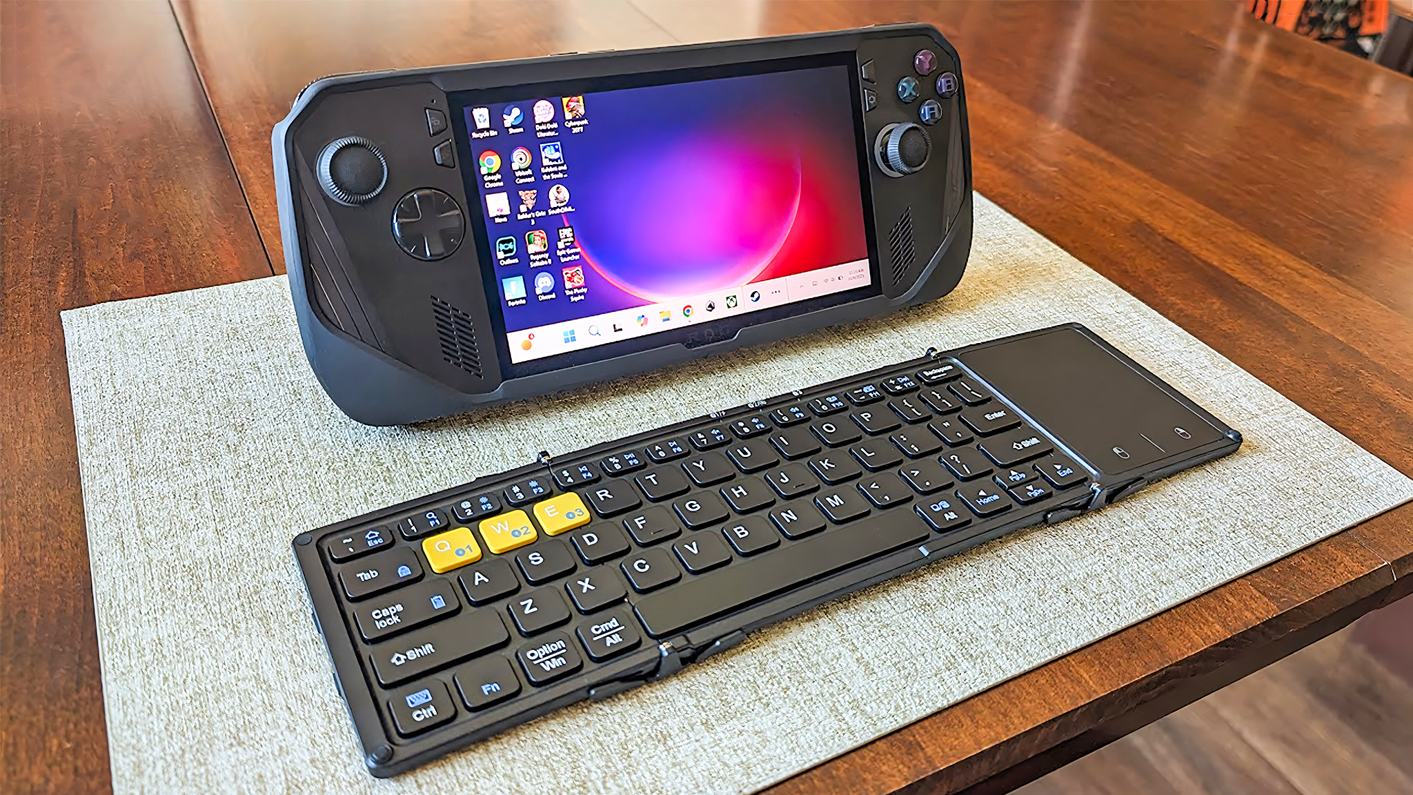 Artciety Foldable Bluetooth Keyboard laying in front of the ROG Ally X.