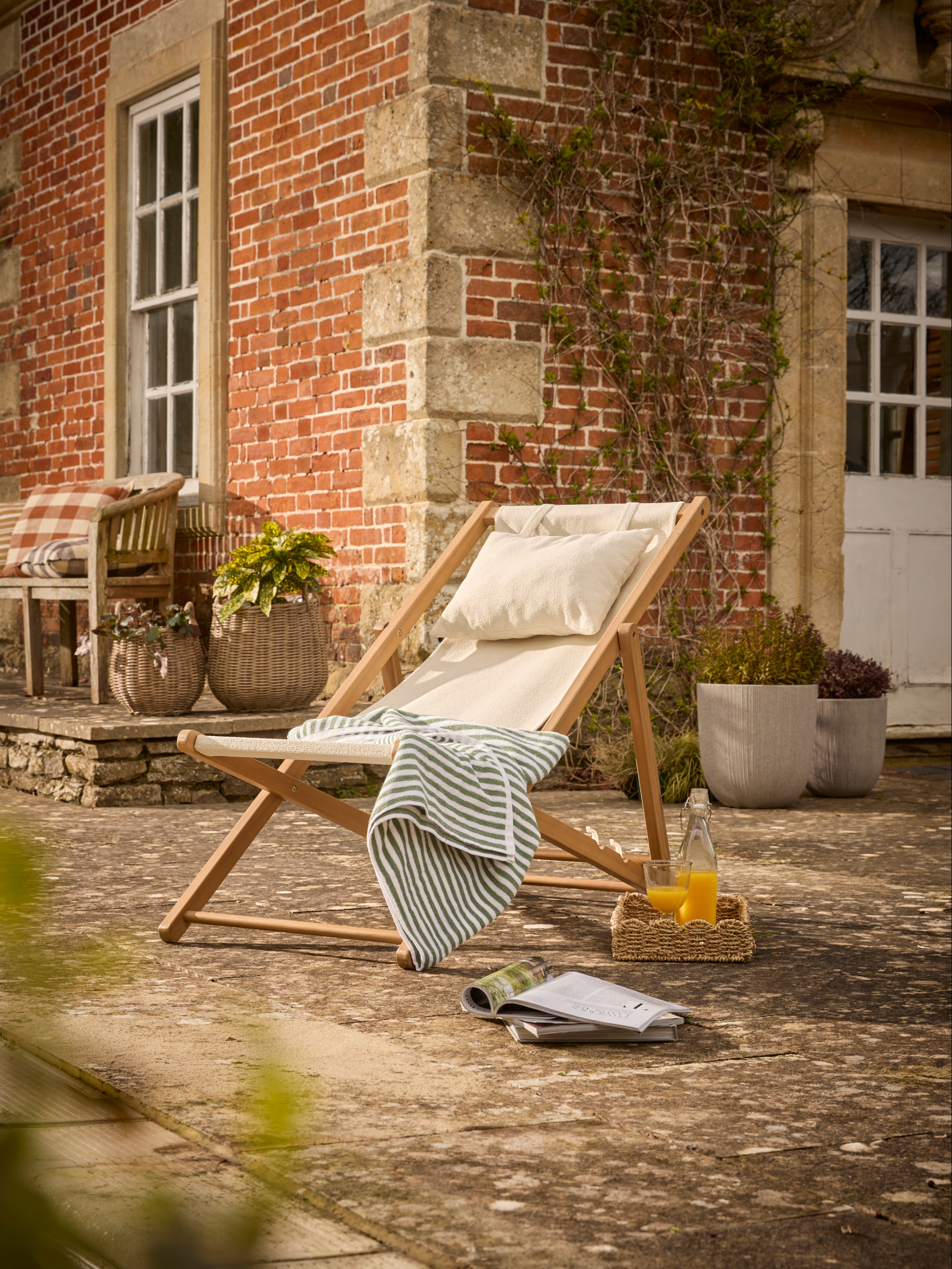 Outdoor deck chair with cream boucle sling