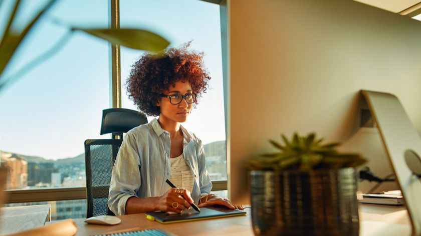 Woman at computer using one of the best drawing tablets for photo editing in her office