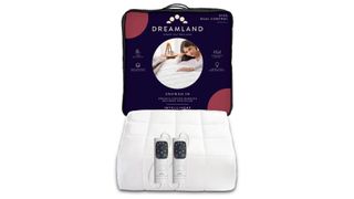 The Dreamland Snowed In Organic Cotton Warming Mattress Protector unboxed with its bag behind it