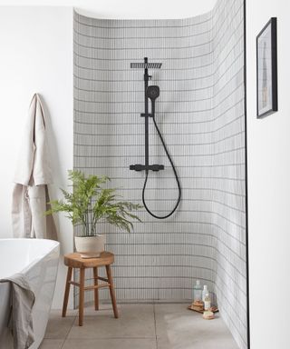 A neutral wet room with a flush tile floor in the shower