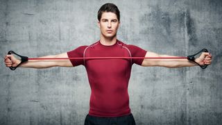 Man stretching arms with resistance band: What is PNF stretching?