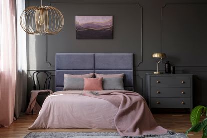 dramatic bedroom with velvet headboard and blush pink bedding