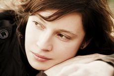 A young woman looks pensive and sad