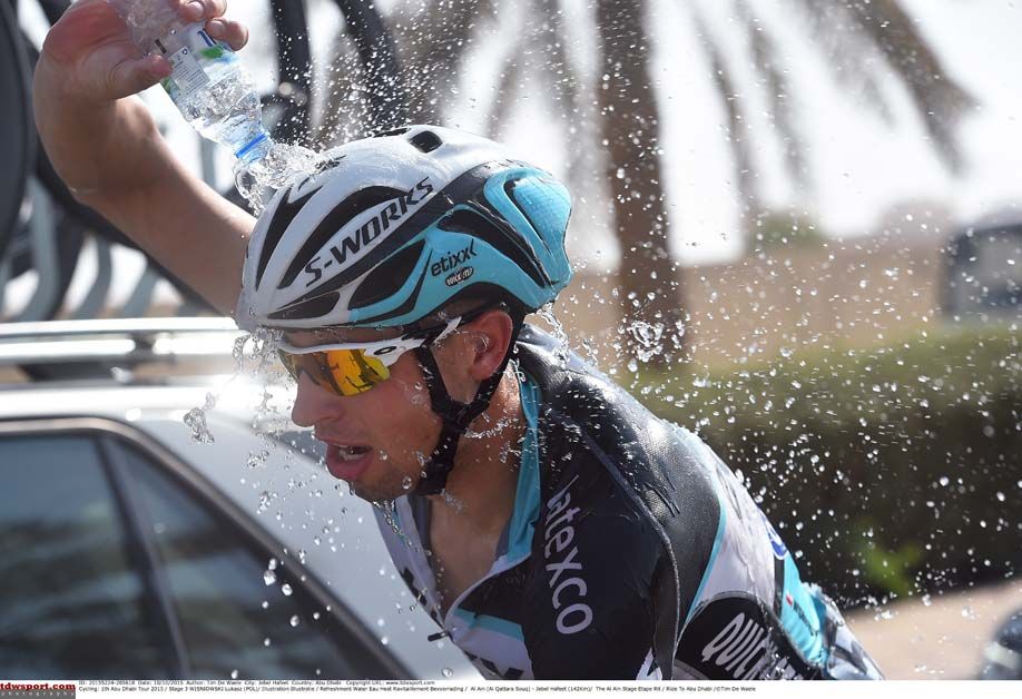 Lukasz Wisniowski throws some water over him during the Abu Dhabi Tour