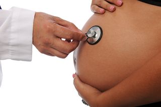 Pregnant belly with stethoscope
