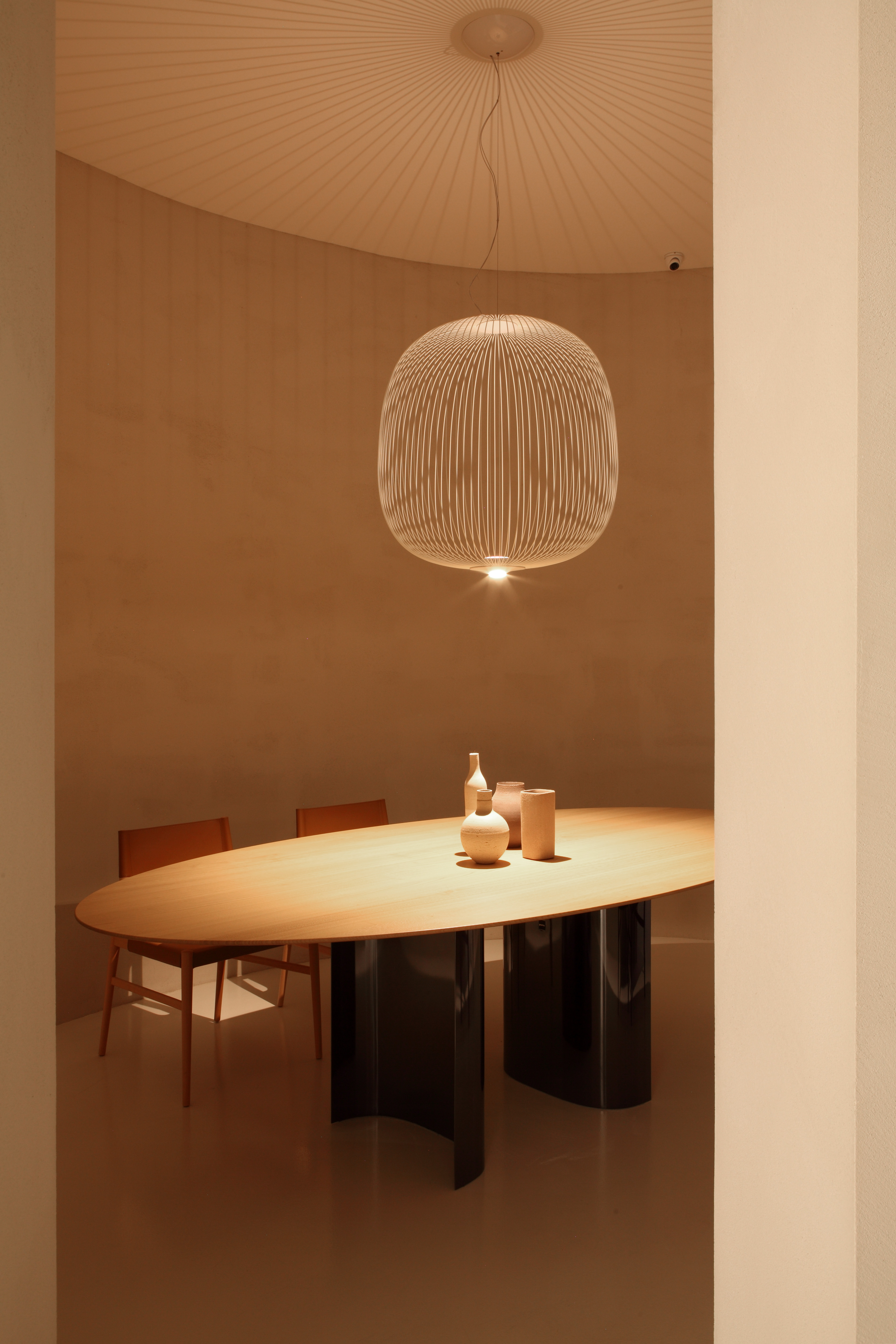 A dining scene which includes Gabriele and Oscar Buratti's Jeff table with GamFratesi's Voyage chairs