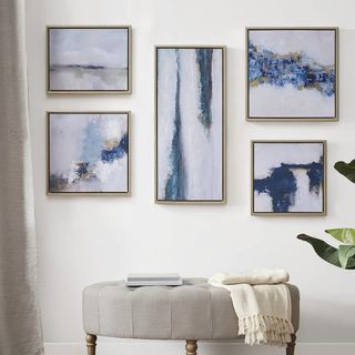 martha stewart gallery set on a neutral wall with a seat in front of them