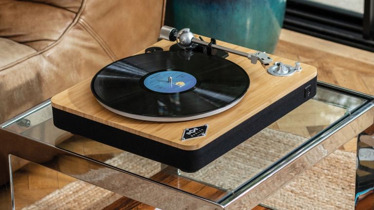 House Of Marley Stir It Up Wireless Turntable review: vinyl player on glass coffee table in natural colored living room