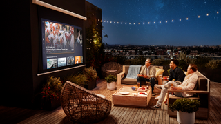 People watching Sling TV on a projector on a rooftop 