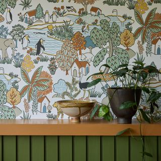 Little Greene Animal Kingdom wallpaper in green, brown and mustard yellow