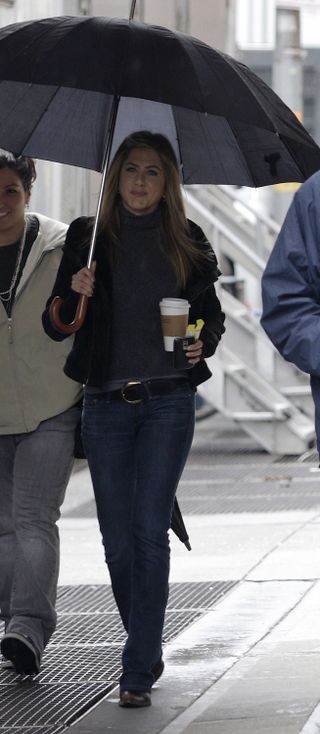 Jennifer Aniston wears bootcut jeans.