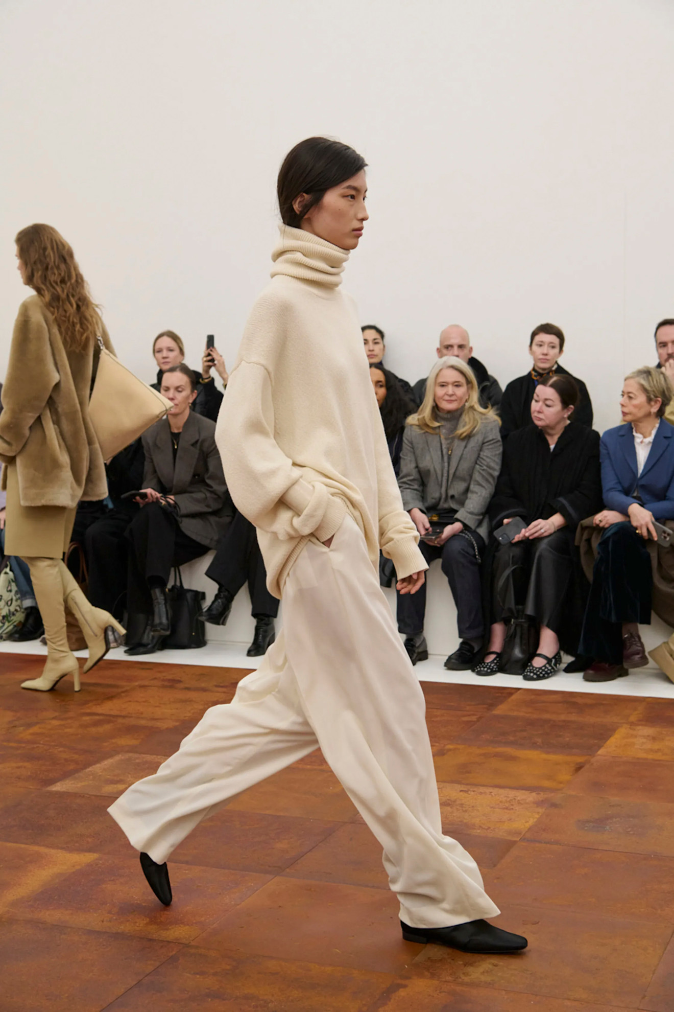 An image of the flat sock boots on the Toteme autumn/winter 2025 runway.