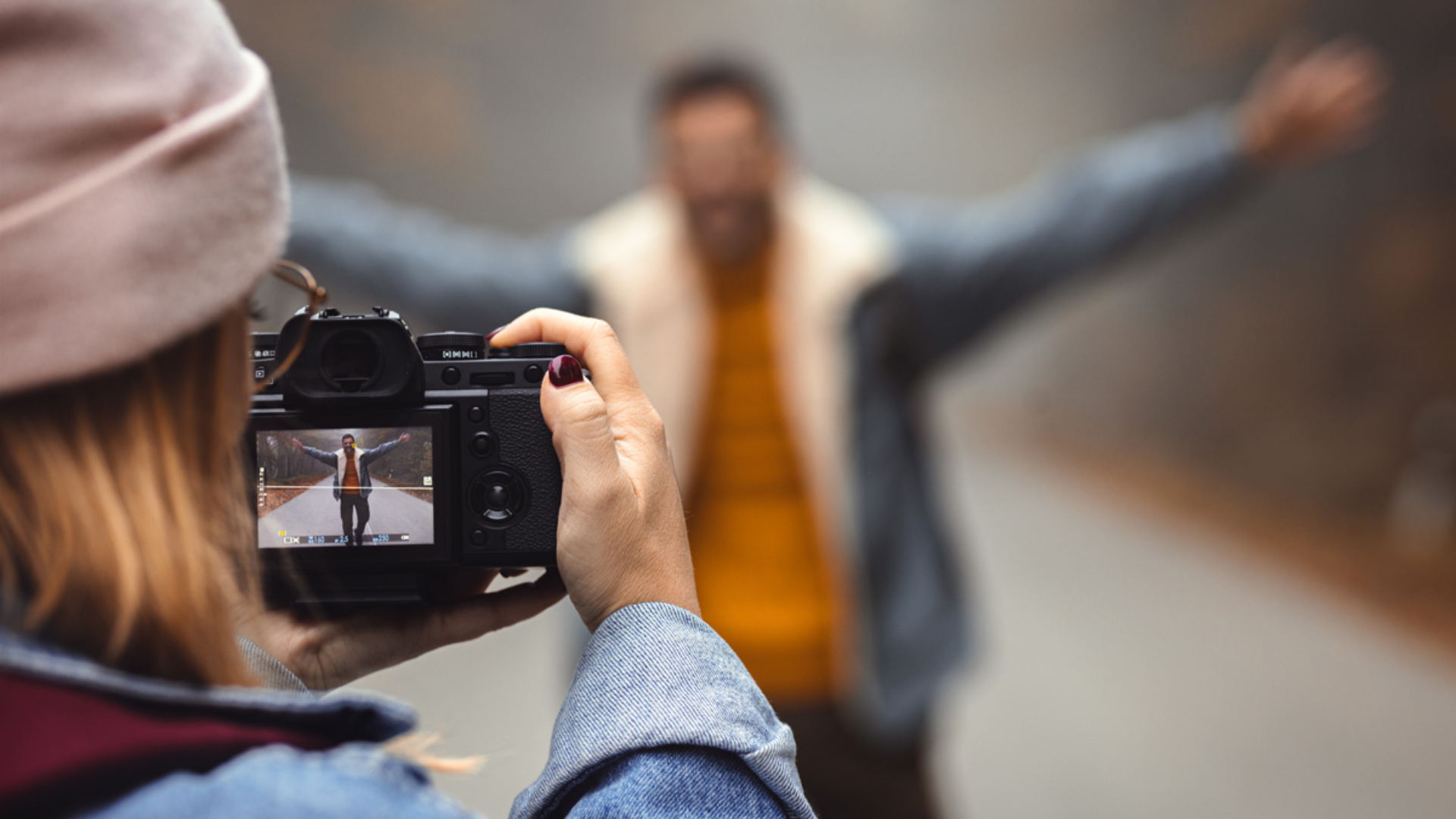 Woman taking a photo of a man