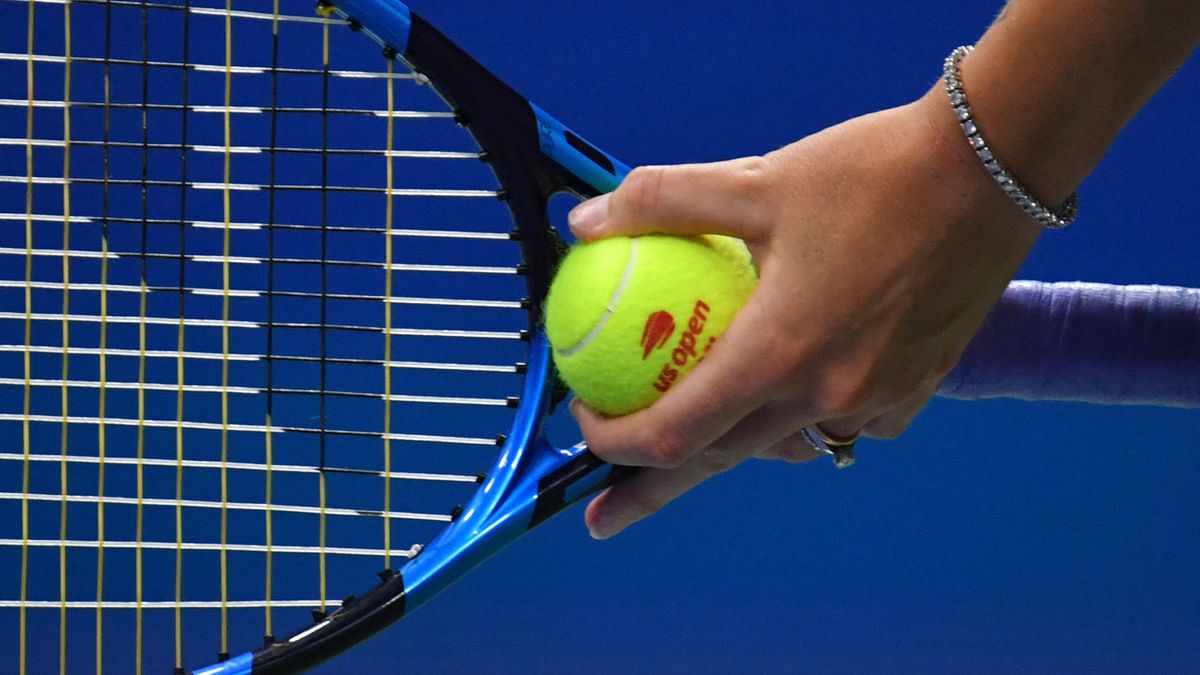 Close-up of tennis racket and US Open branded tennis ball at the US Open