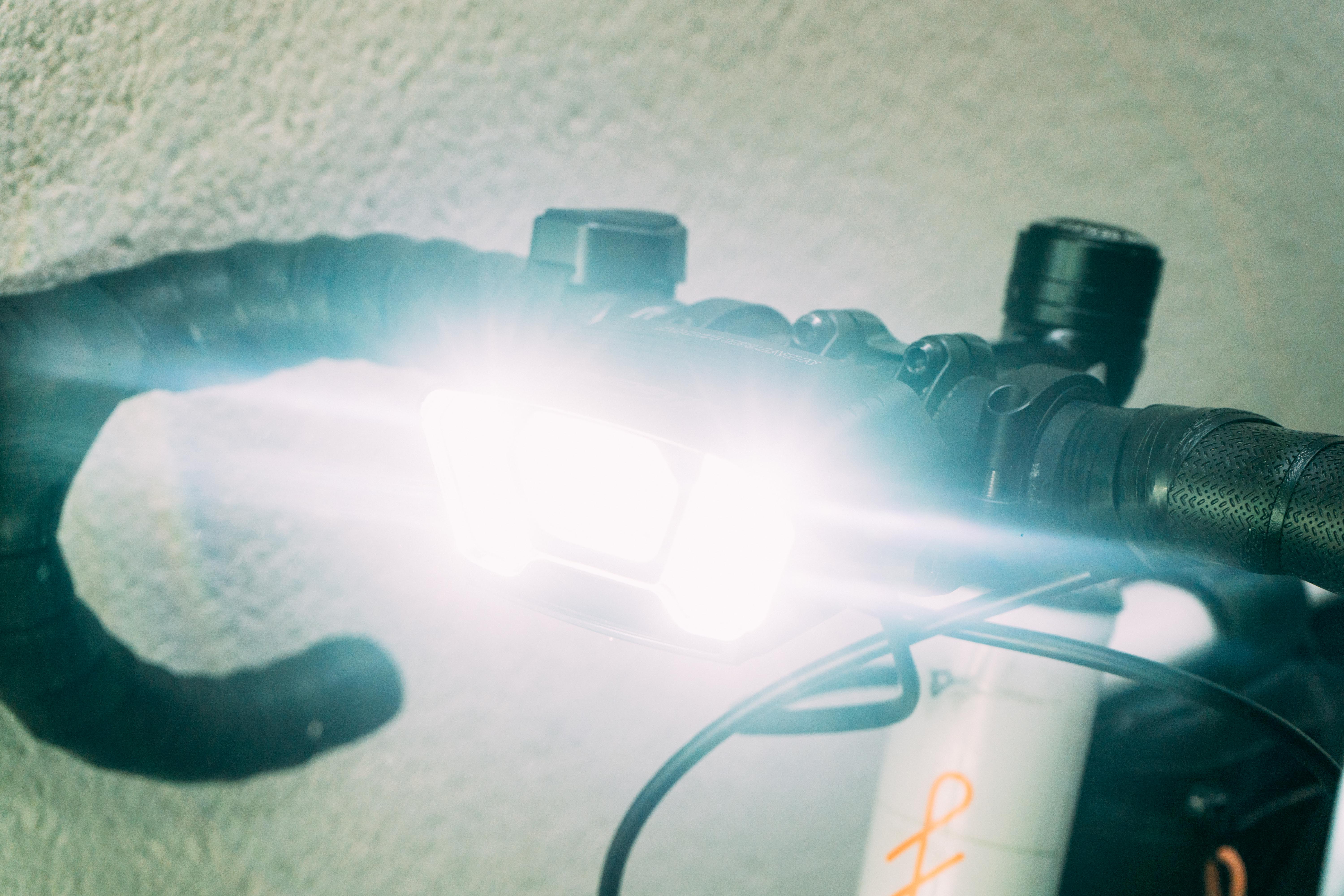 A large bike light at full power emitting a blinding white light