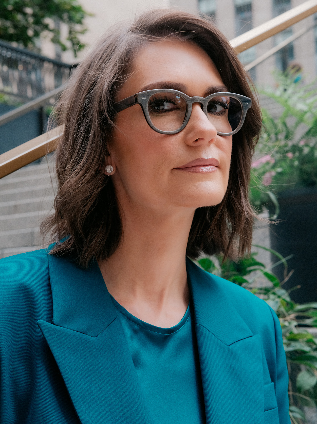 Close-up portrait of Jessica Tarlov wearing glasses and a teal blazer.