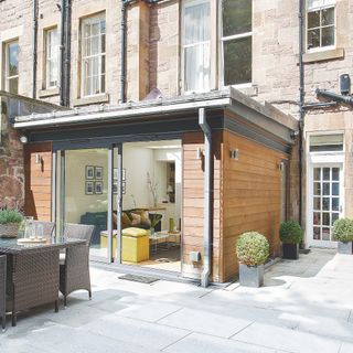 building with stone wall and outdoor table