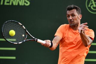 Former footballer Paolo Maldini returns a ball during a tennis doubles match at an ATP Challenger event in 2017.