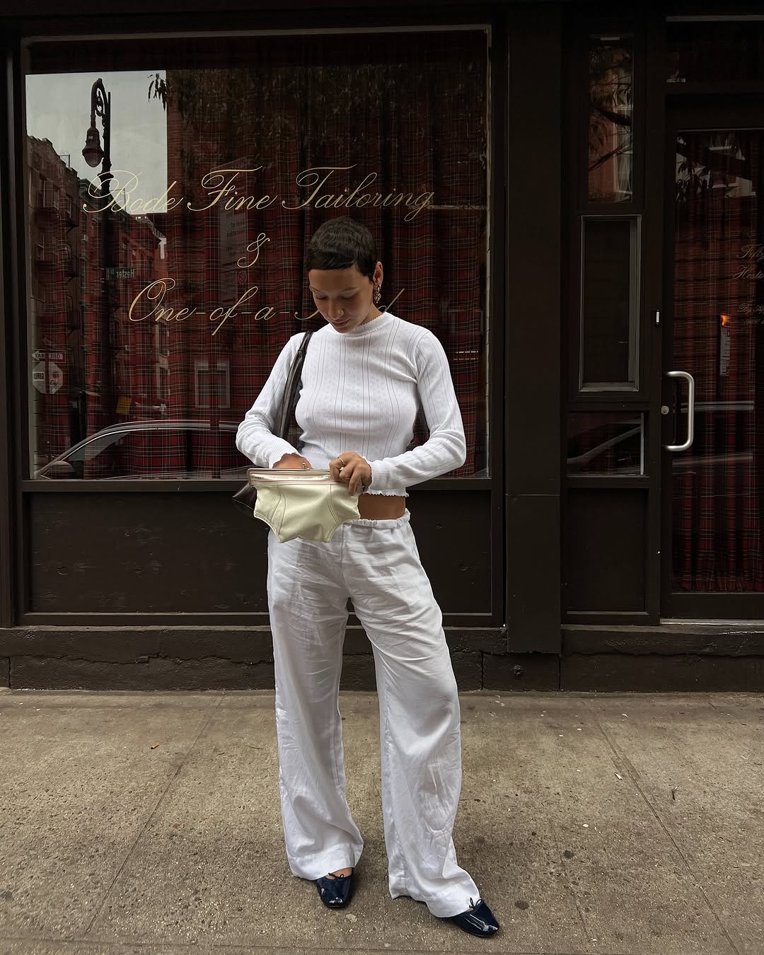 woman wearing cotton pointelle top and white linen pants summer 2025