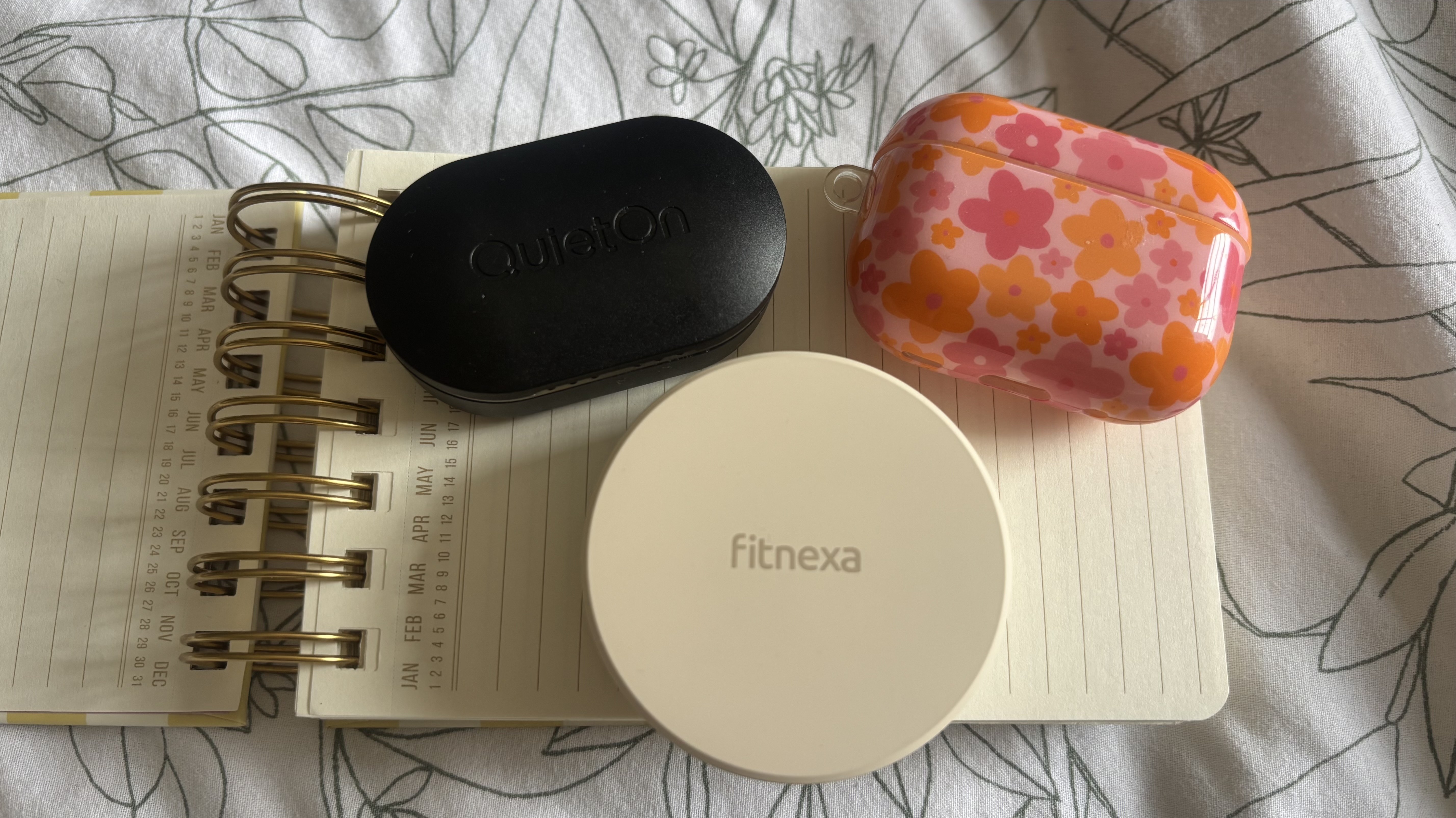 A size comparison of the QuietOn 4 case, the Fitnexa SomniPods case, and the Air Pods Pro 2 case. 