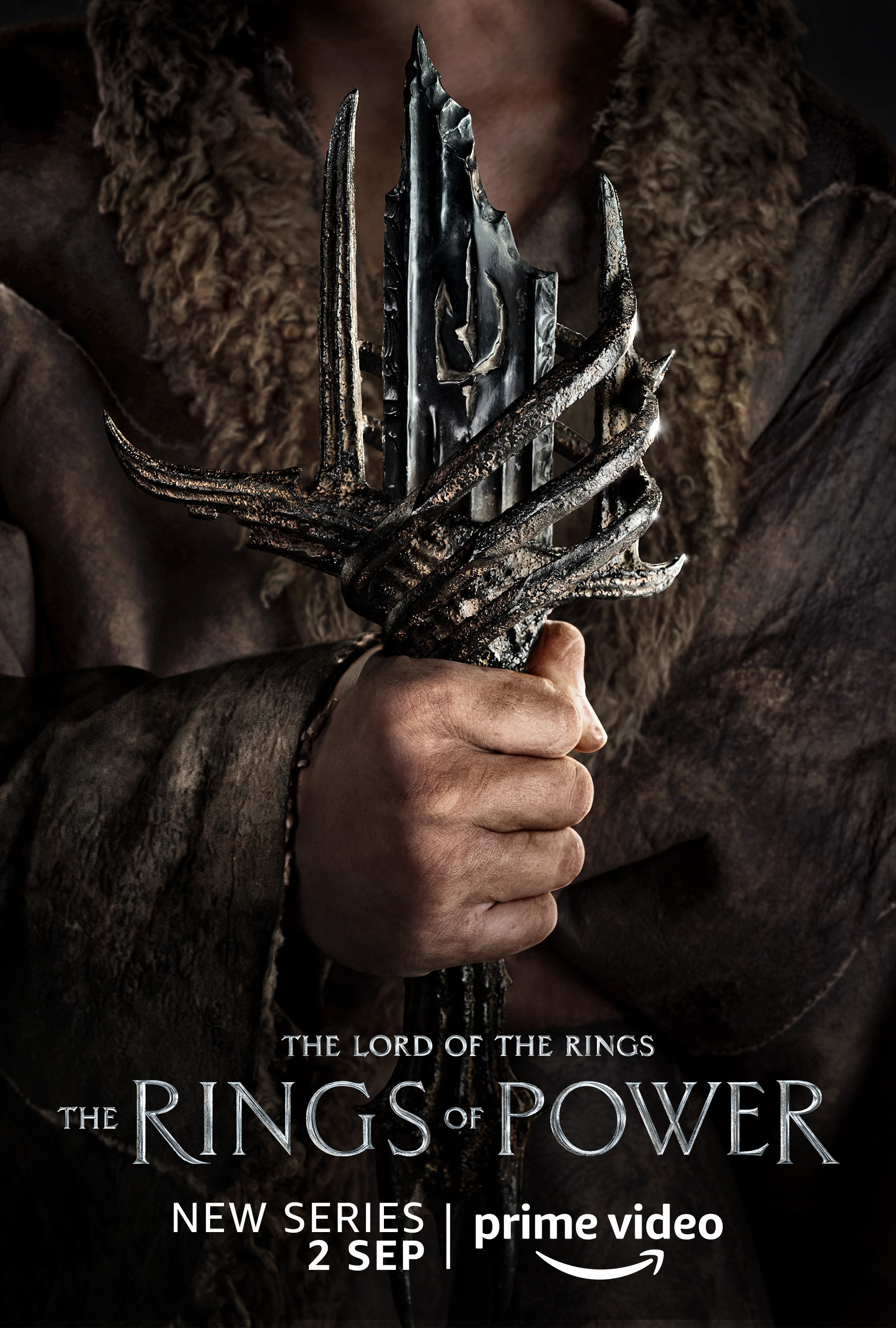 A man holding a broken sword character poster for Lord of the Rings: The Rings of Power