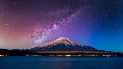 a mountain with a starry sky behind it