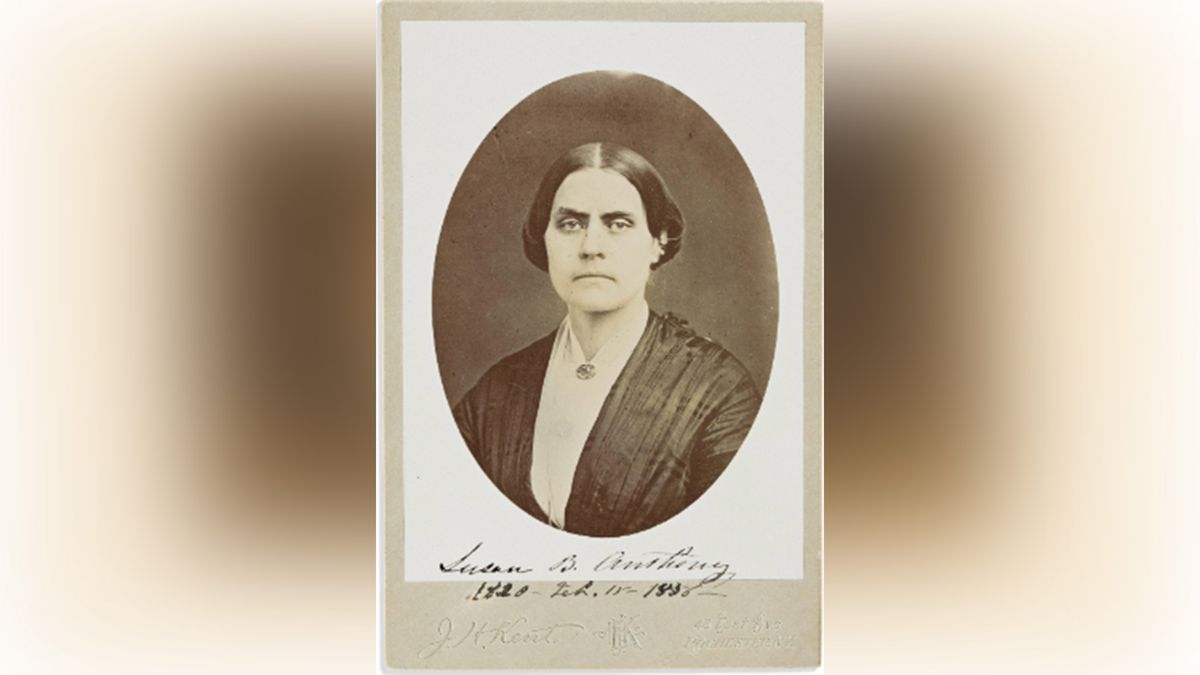 Black-and-white portrait of a stern-looking woman.