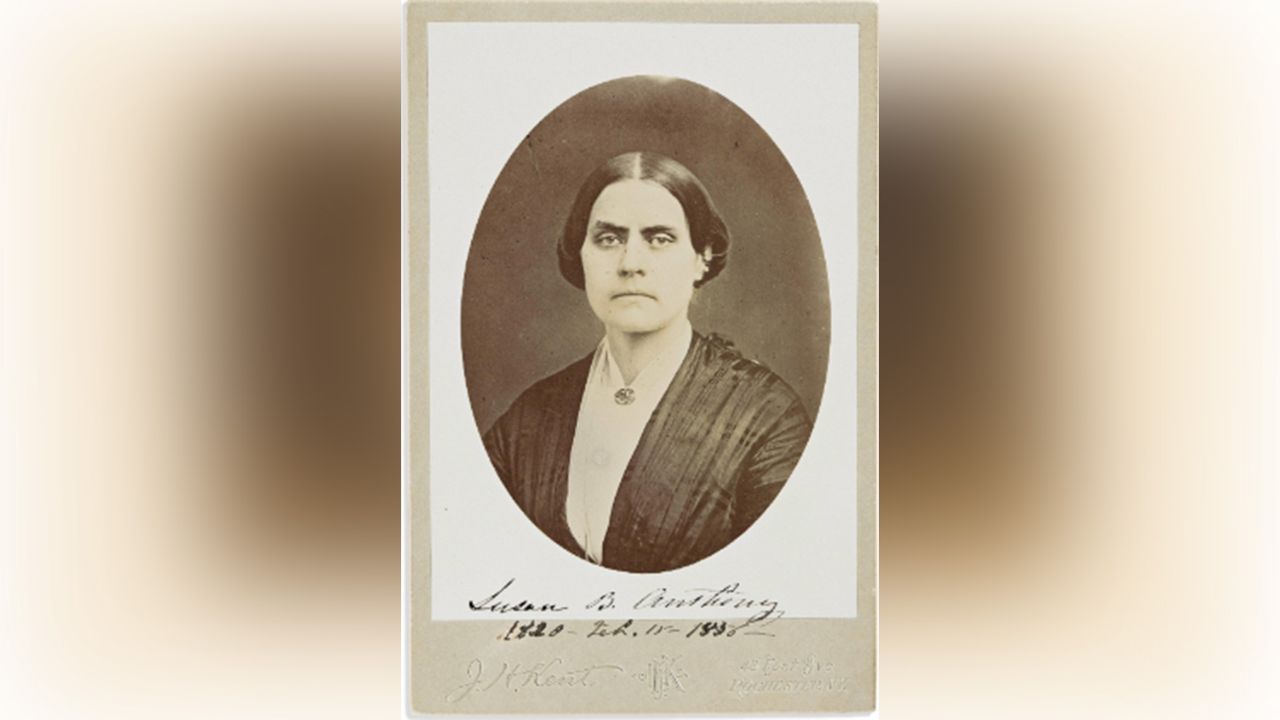 Black-and-white portrait of a stern-looking woman.