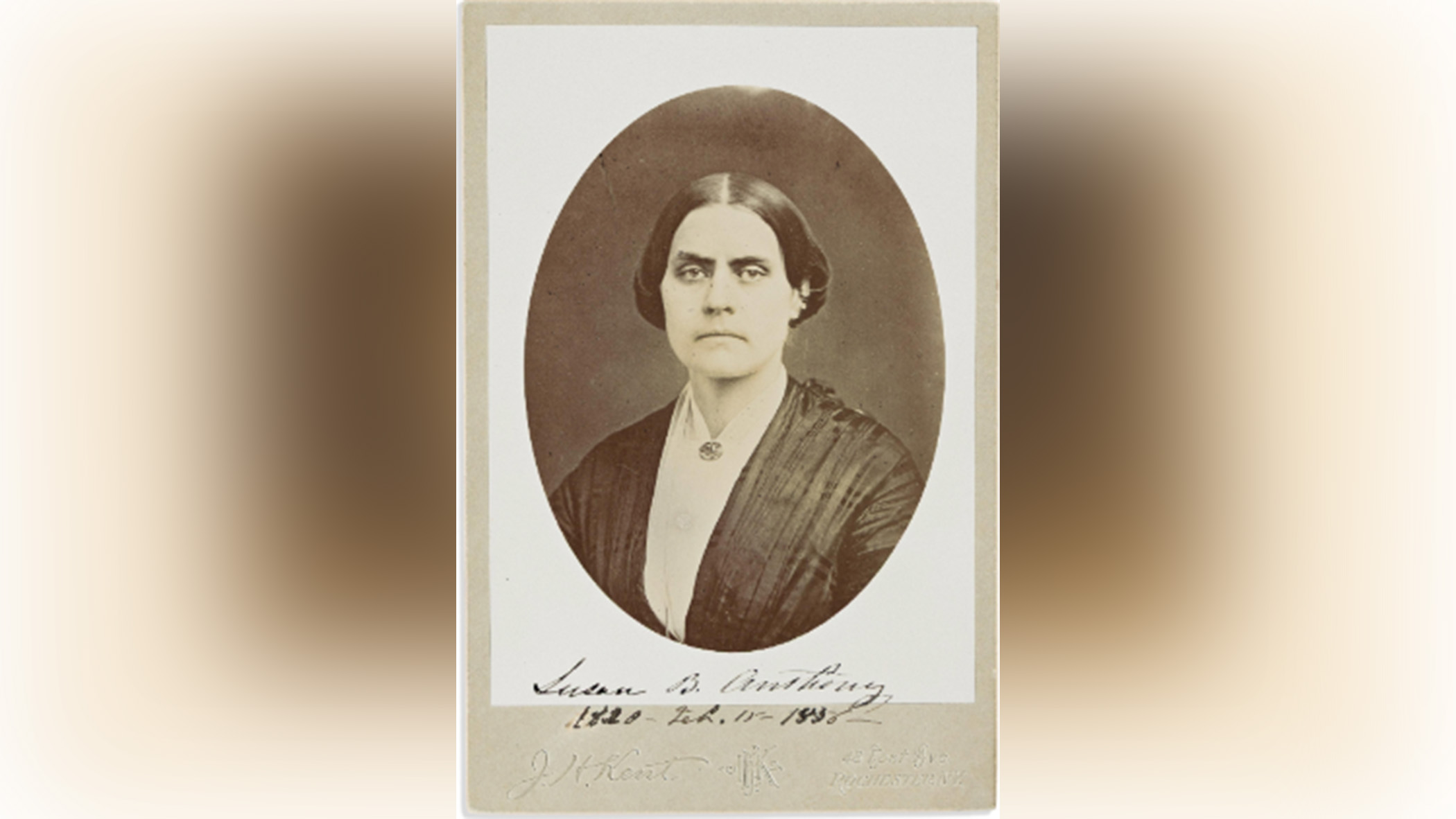 Black-and-white portrait of a stern-looking woman.