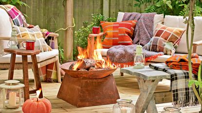 metal colored fire pit on a wooden deck surrounded by comfy seating