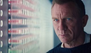 No Time To Die Daniel Craig scowling at some red vials