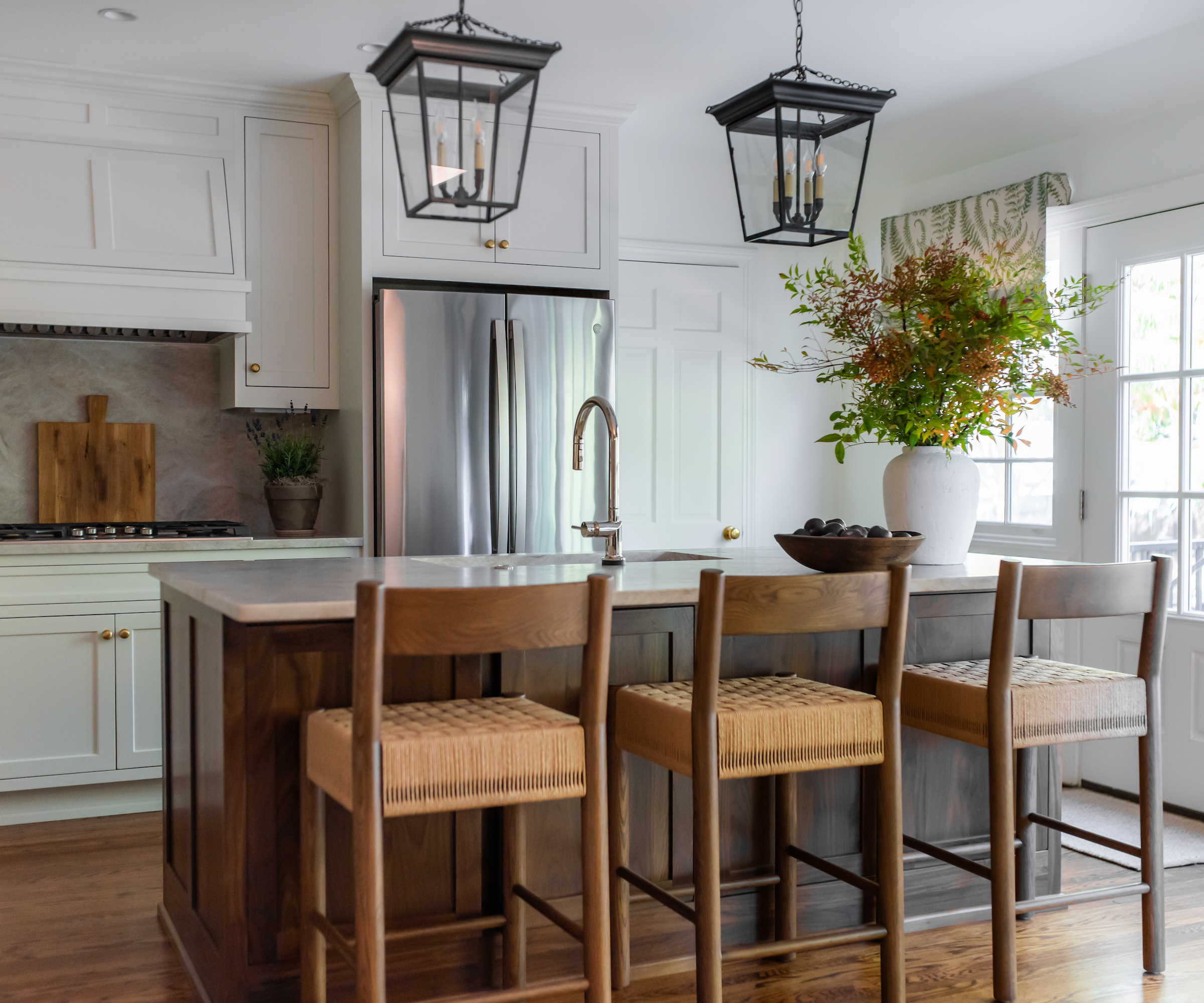 white kitchen with island and wood stools