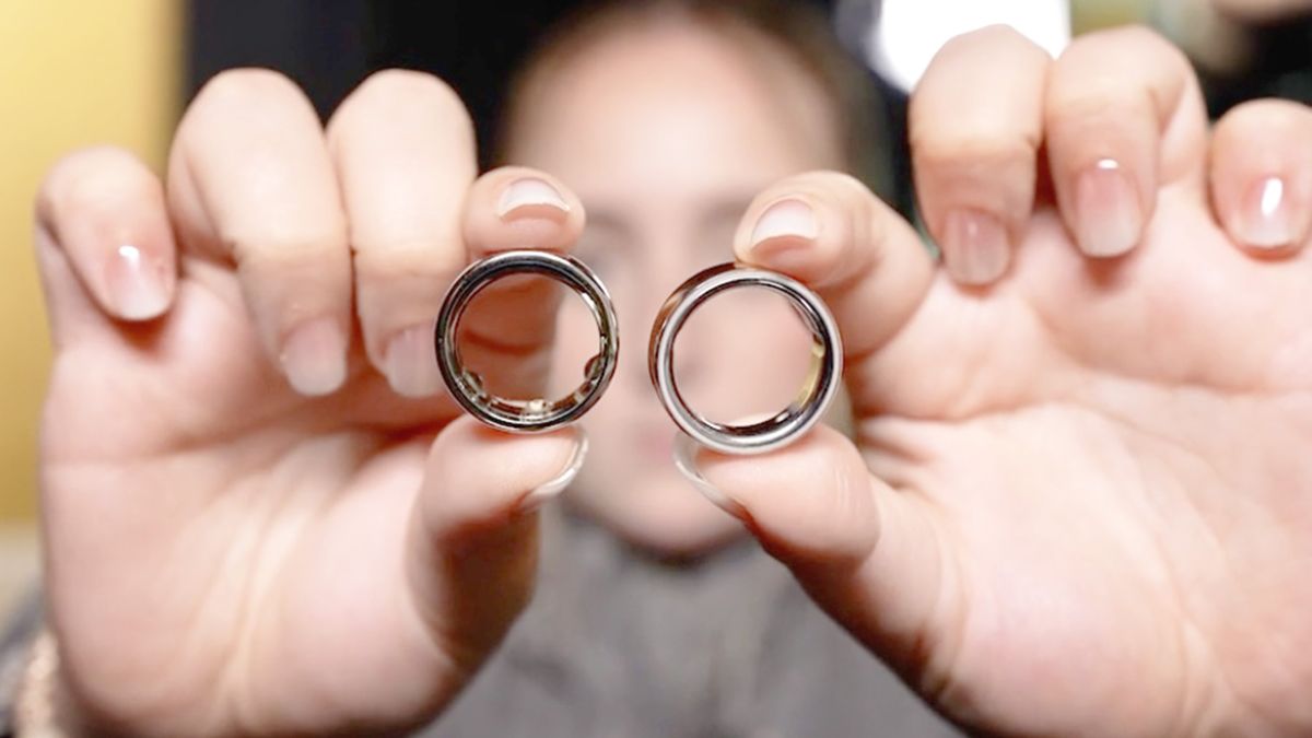 Close up of a user showing two Oura Ring models side-by-side