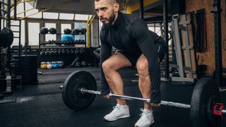 Man in the starting position of the deadlift exercise