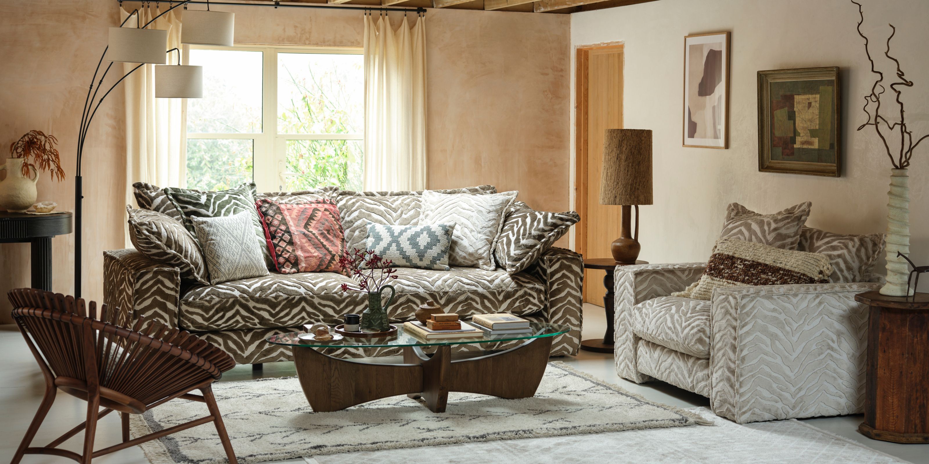 Subtle zebra print furniture in white and brown colours with aztec cushions