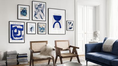 Modern living room with blue gallery wall of framed sculptural prints