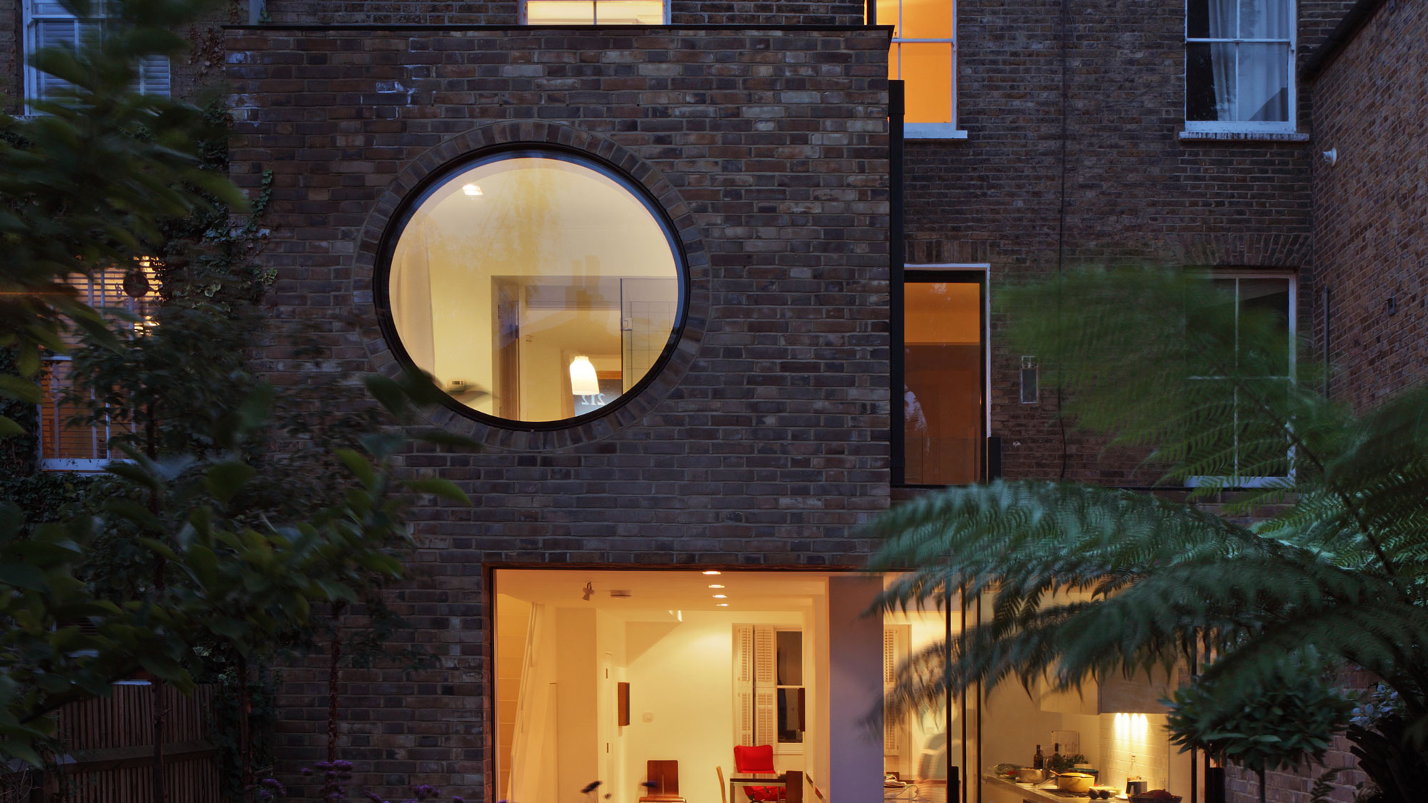 two storey extension with large circular window at first floor