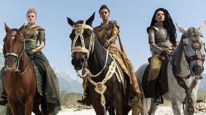 Elayne, Egwene, and Nynaeve dressed regally and on horseback in The Wheel of Time season 3