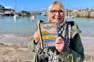 Fern Britton poses with a guide to Cornwall