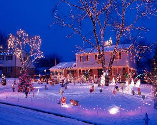 Christmas lights on snowy house