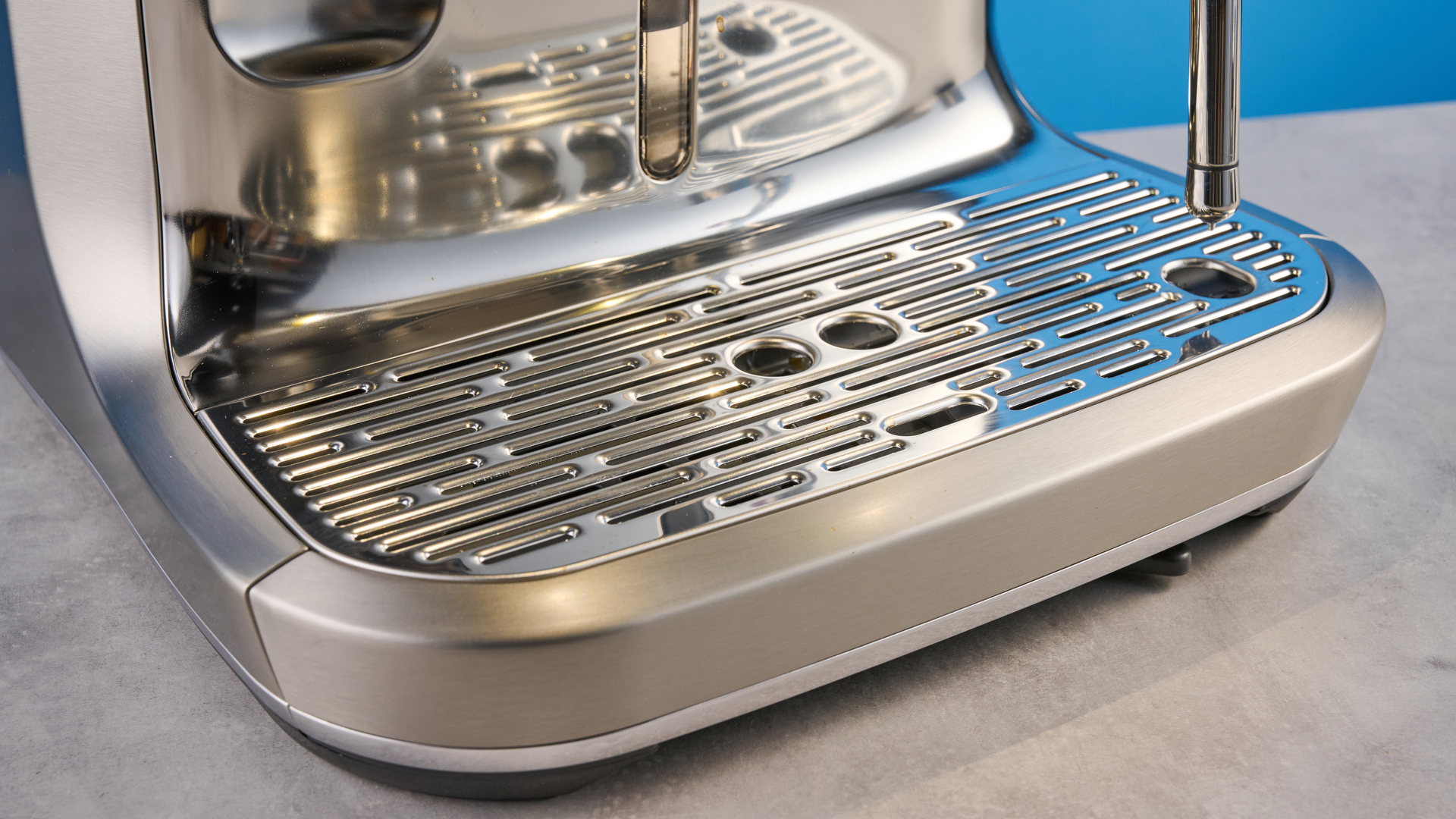the breville oracle dual boiler / sage oracle dual boiler in stainless steel, showing its touchscreen, steam wand, built in grinder, and espresso shots