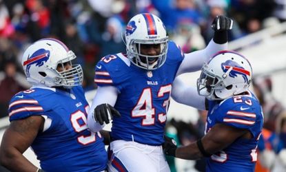 Buffalo Bills linebacker Bryan Scott (center) celebrates an interception during a Dec. 30 home game.