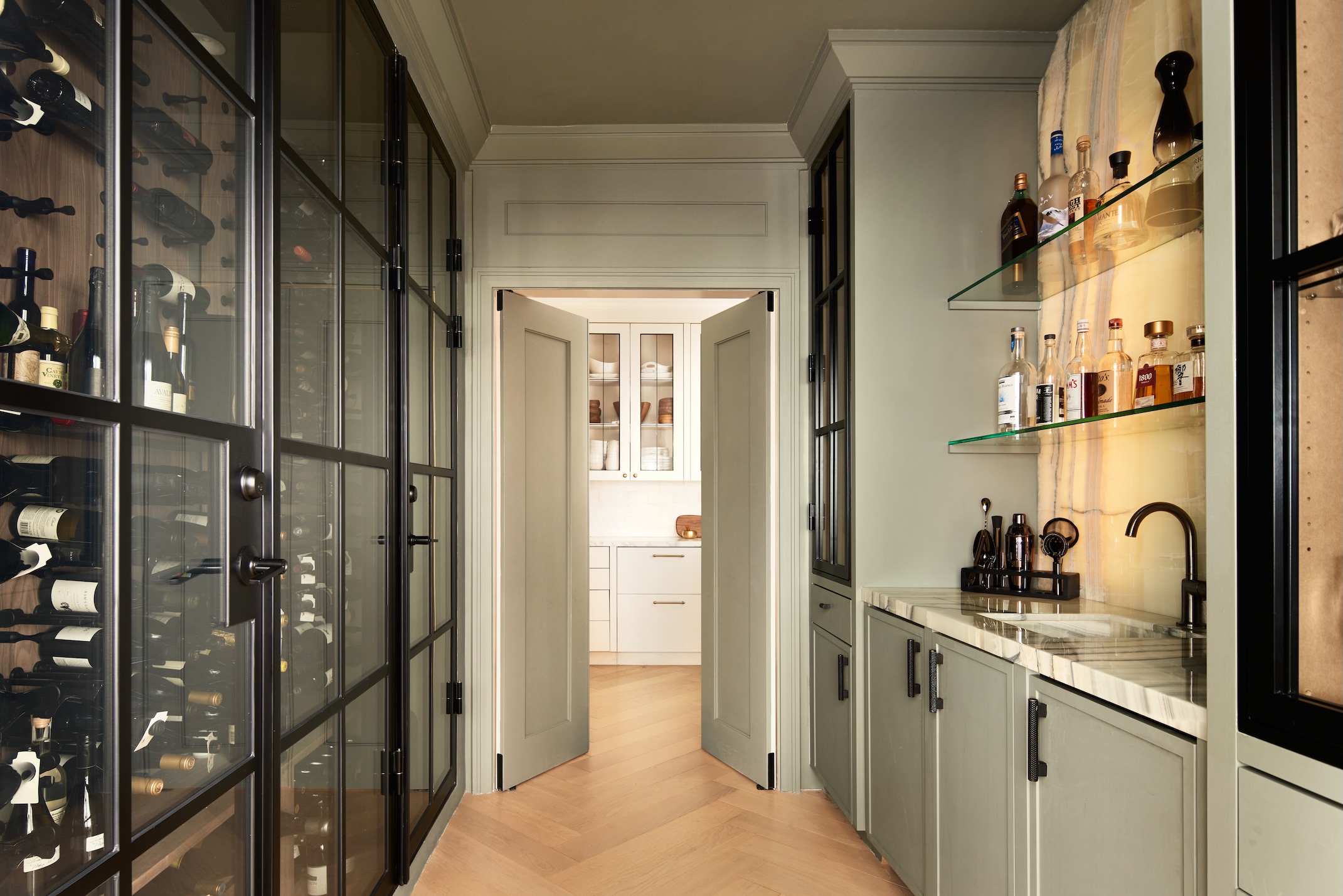 A multifunctional kitchen with a bar and wine fridge built in to a small footprint