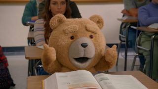 Ted flashes his thumbs up while sitting at a school desk in Peacock's Ted.