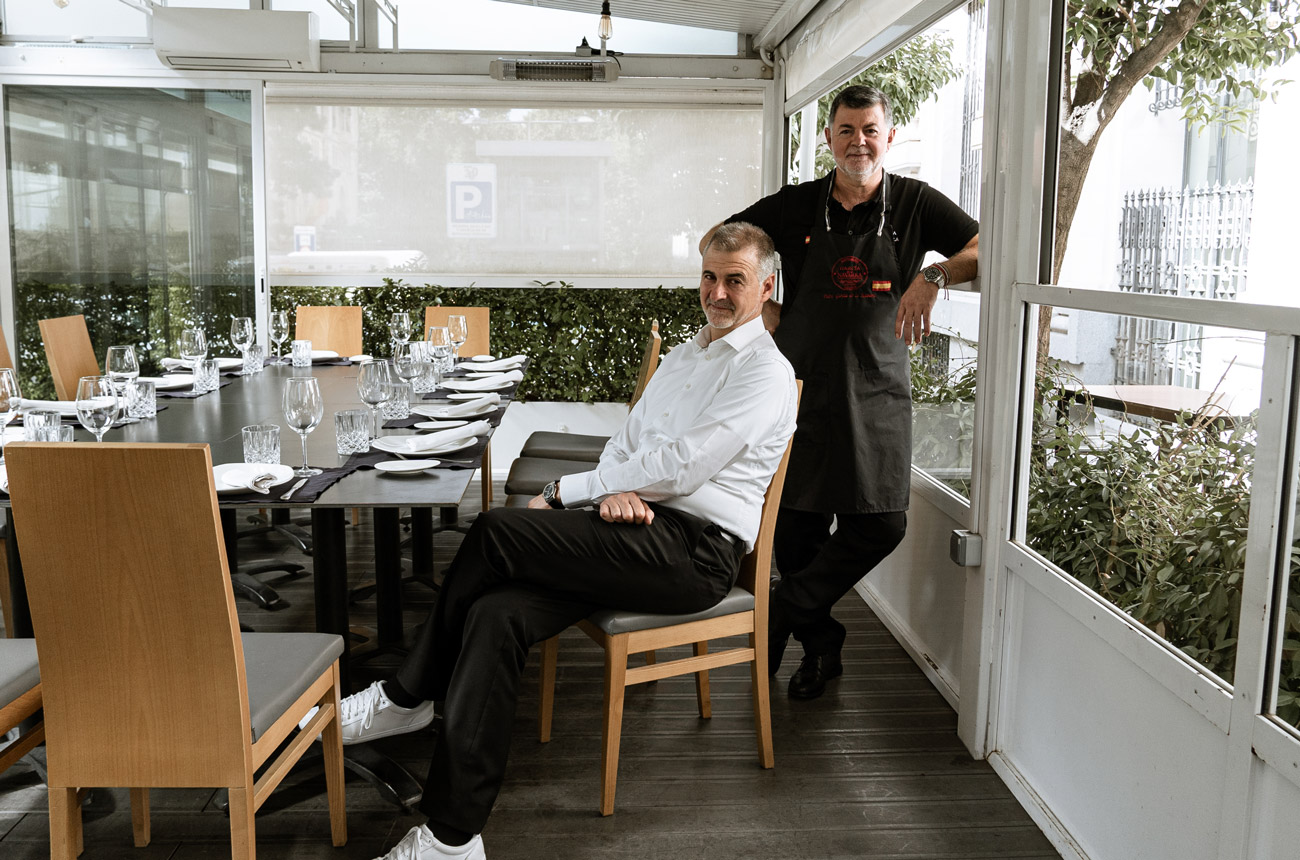 Two men sitting in their restaurant